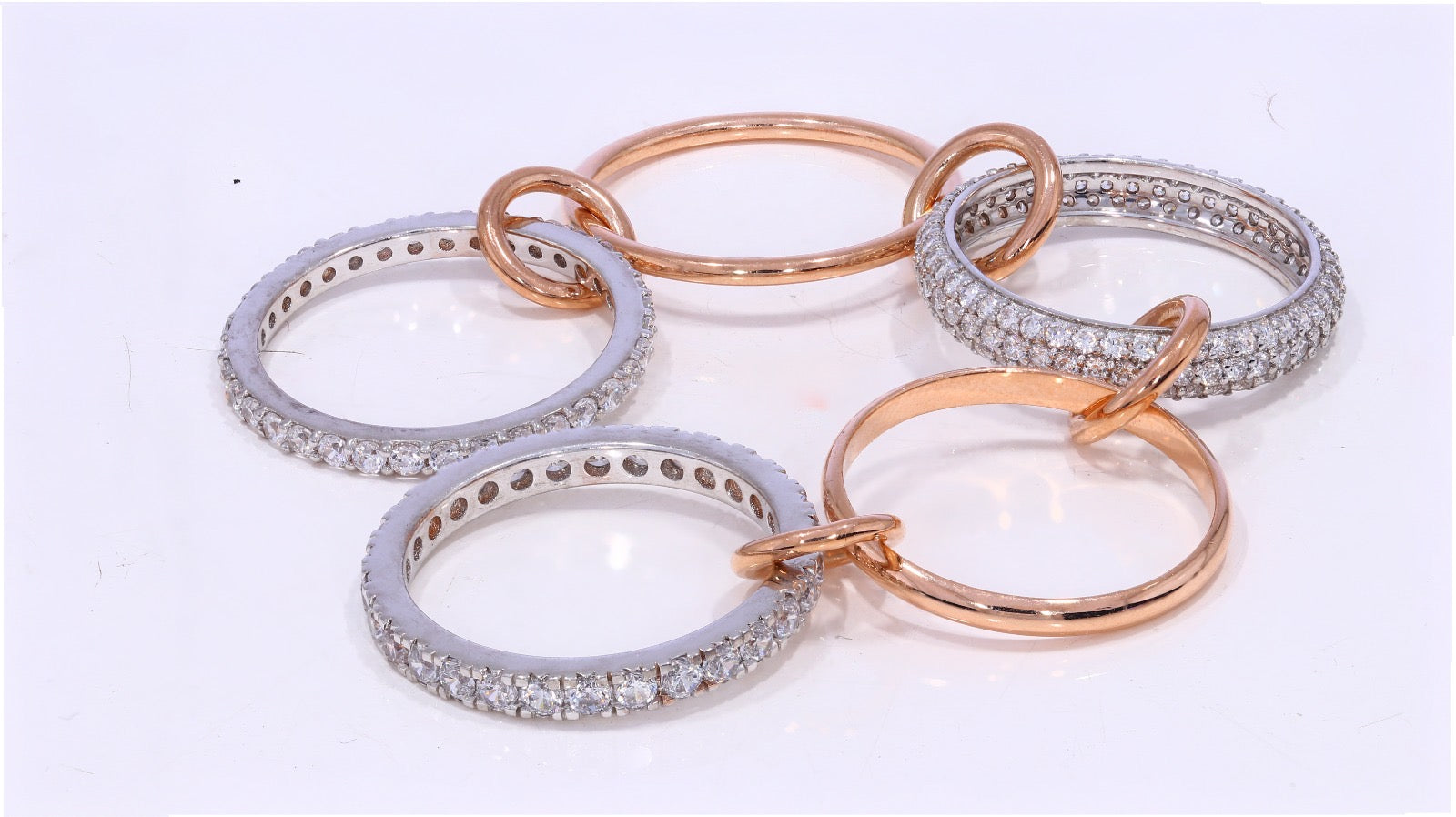 Locked and stocked ring sustainably grown diamond eternity bands in white and rose gold linked together
