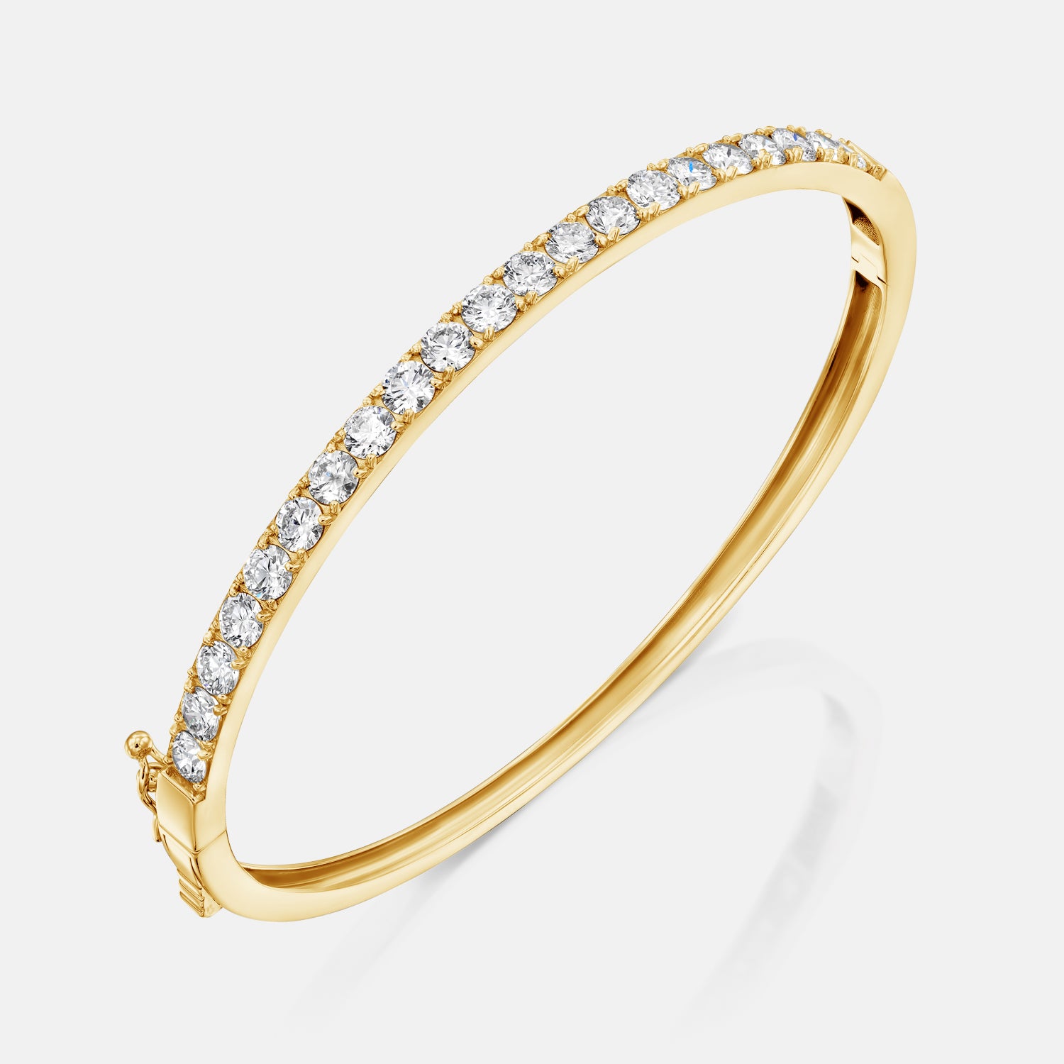 Yellow gold All Day Everyday Bangle angled diagonally to reveal its smooth interior and clean finish.