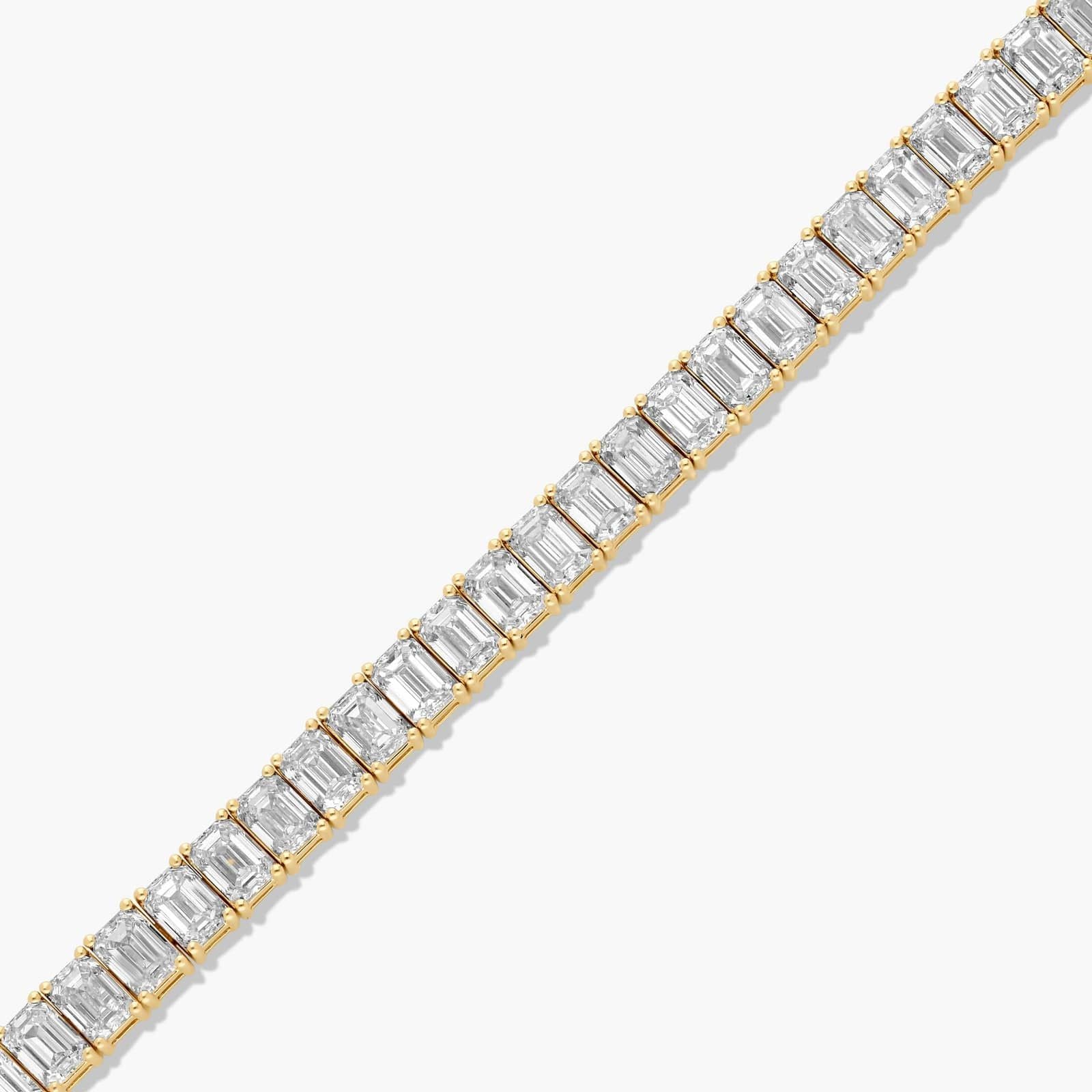 Open layout of the Always Evolving tennis bracelet with emerald cut diamonds fully visible in a straight line.