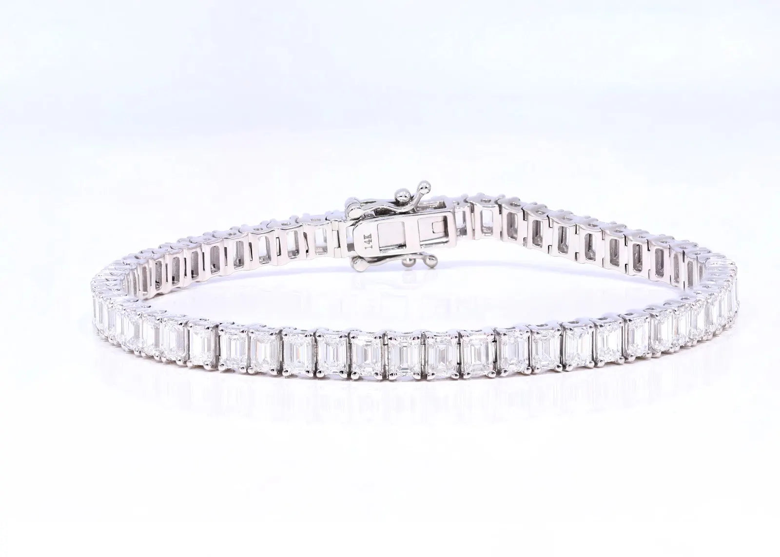 White gold Always Evolving tennis bracelet photographed from an angled perspective with close focus on clasp and link design.