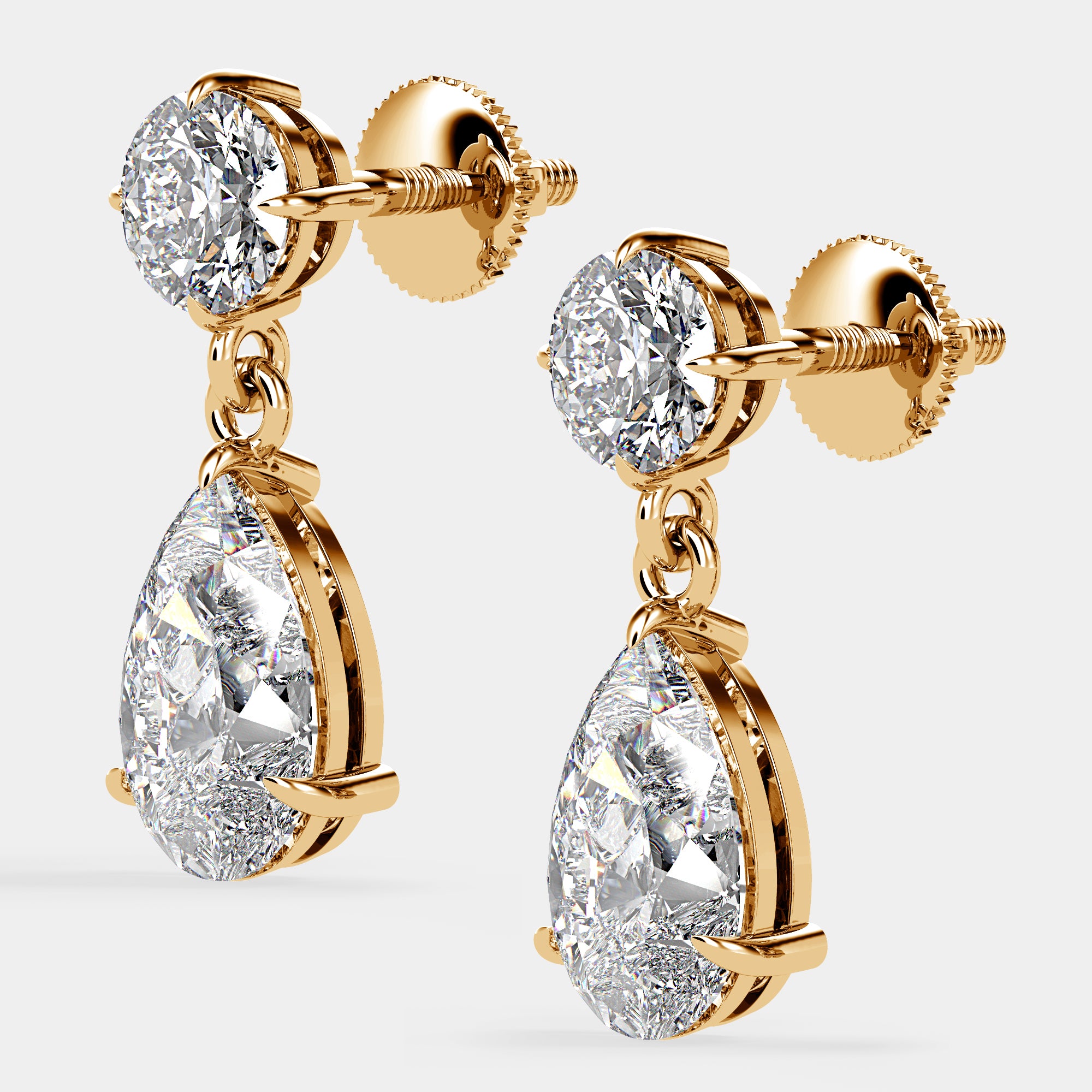 Side view of yellow gold Bougie Baby Drop Earrings highlighting round and pear diamond pairing