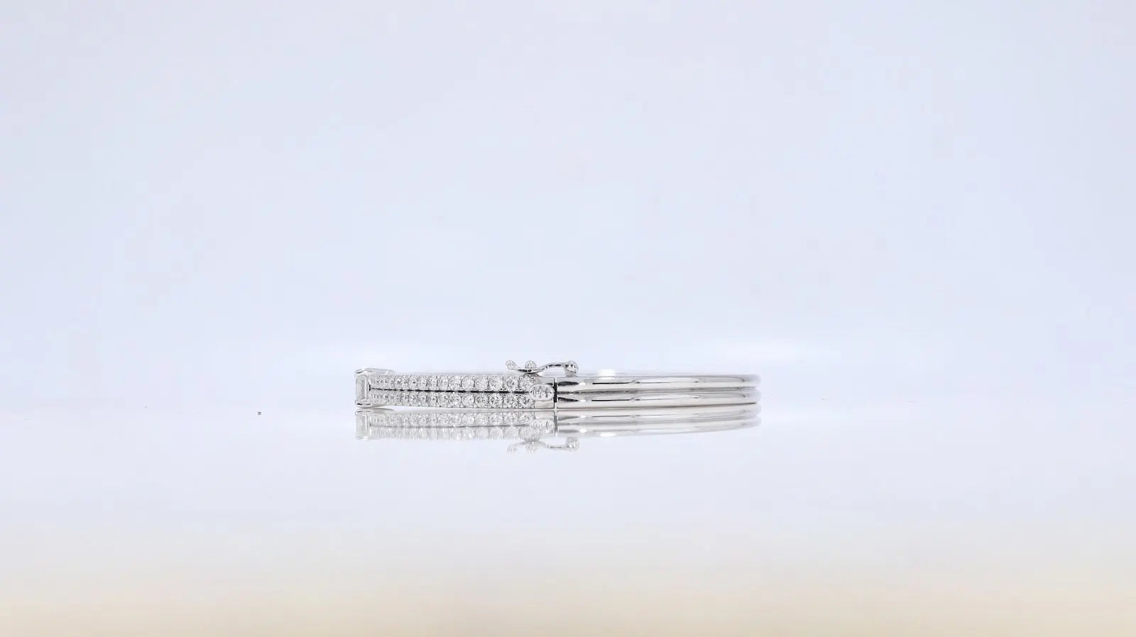 Side view of The Clarity Bangle in white gold showing closure detail and diamond craftsmanship