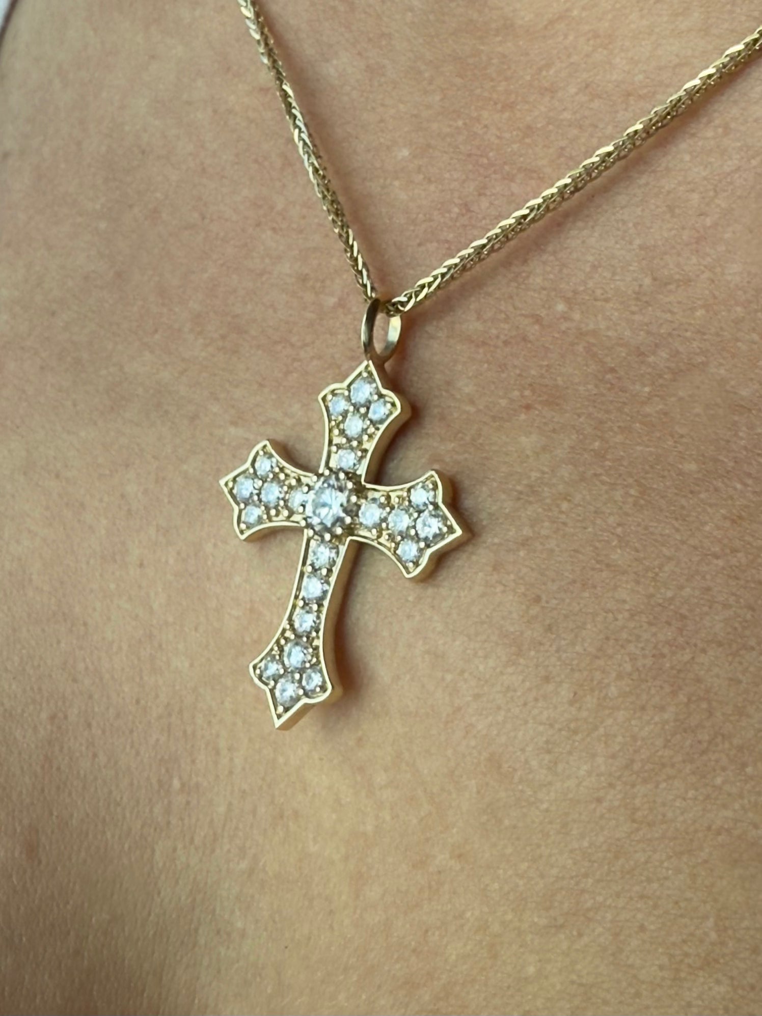 Close-up of model wearing the Thou Shall Not Fear pendant in yellow gold showcasing its shine and craftsmanship