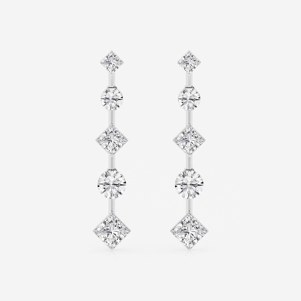 White gold Double Feature earrings showcasing princess and round cut diamonds in a modern drop design