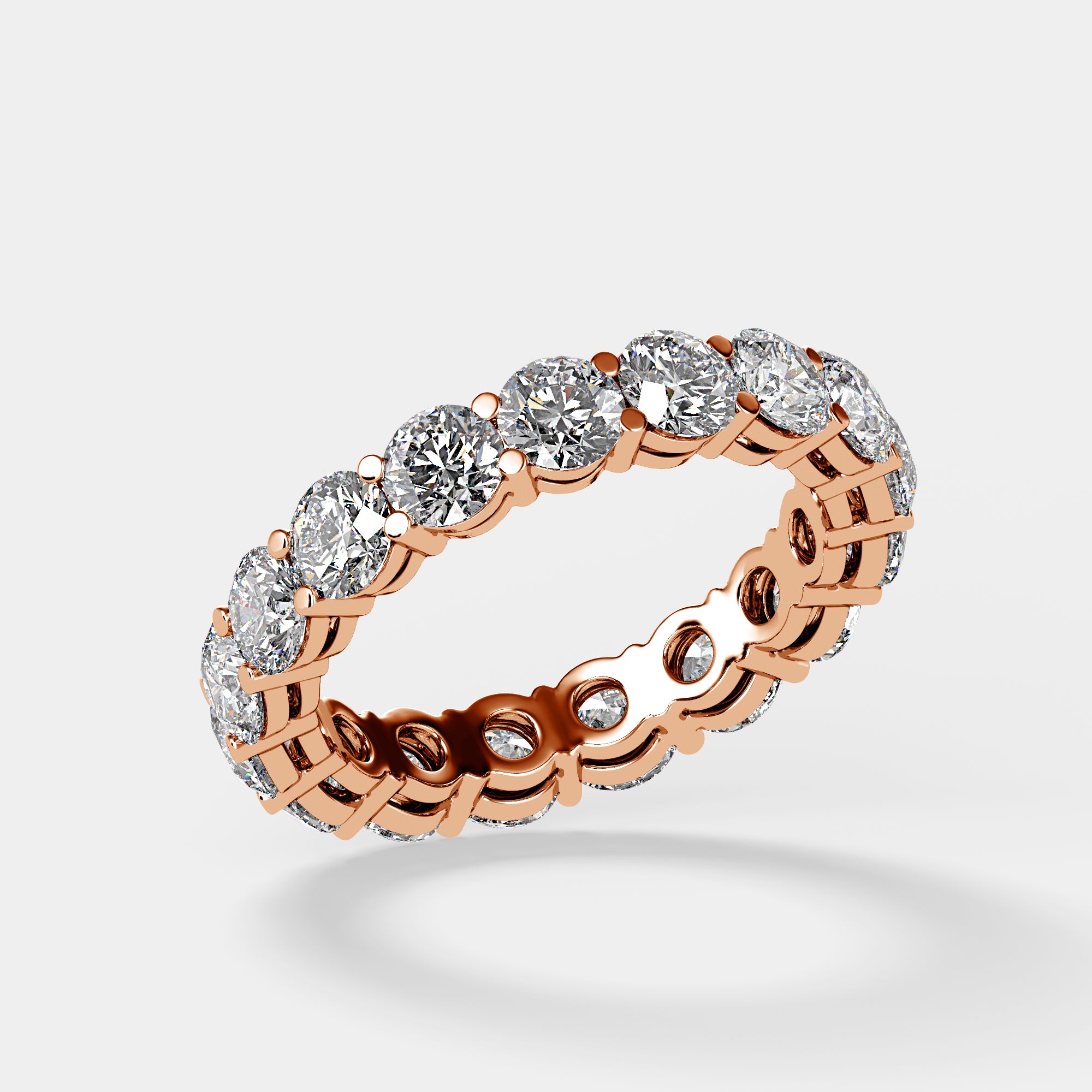 Rose gold eternity band with round brilliant diamonds, angled front view