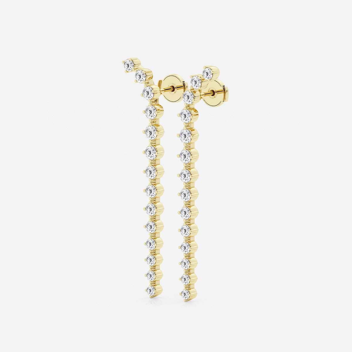 Side view of Lyrical Descent earrings in yellow gold with flowing diamond arrangement.