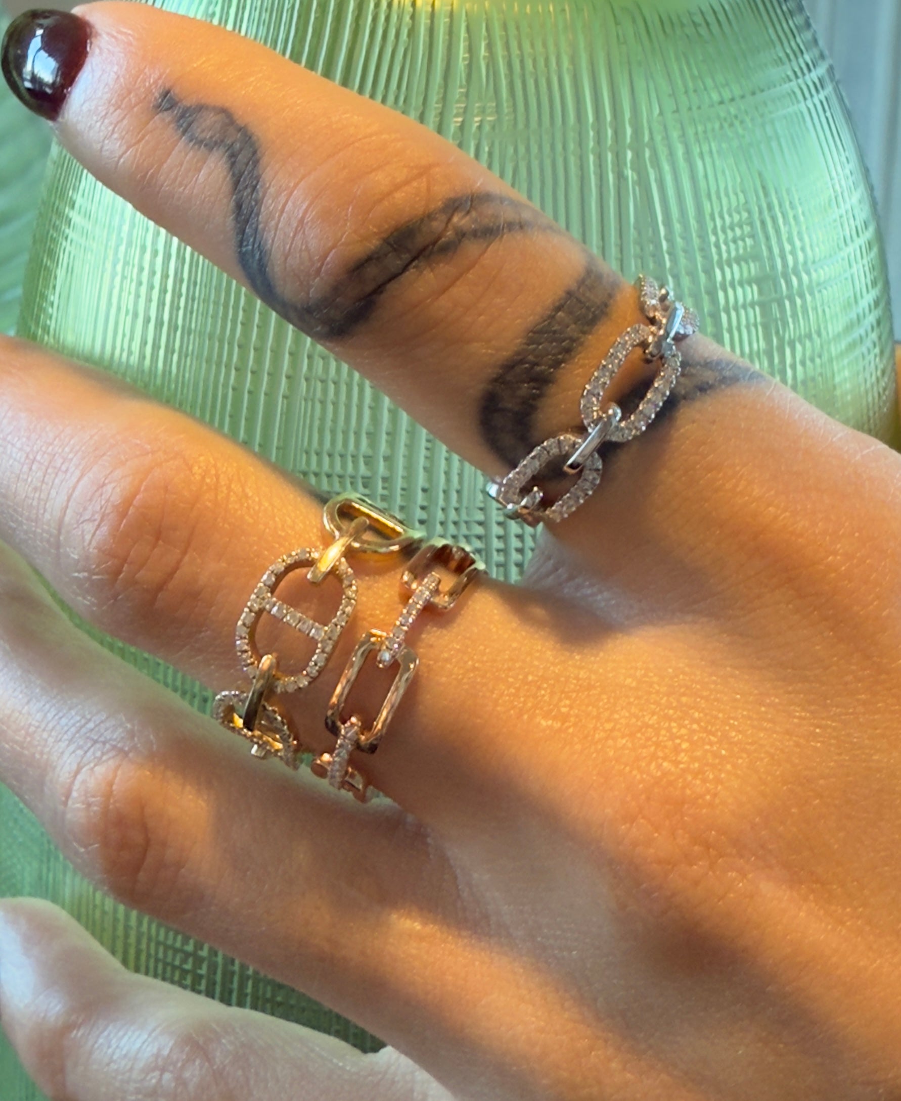 Editorial shot of Money Link Pavé Ring stacked on model’s finger, gold mariner chain style