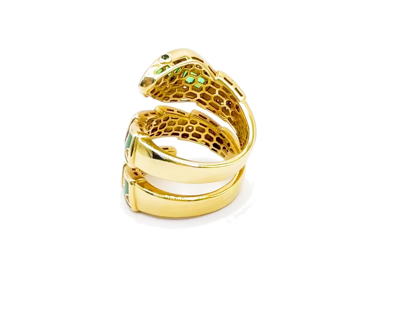 360-degree view of the She Bites Snake Ring in 18k gold with emerald and diamond detailing.