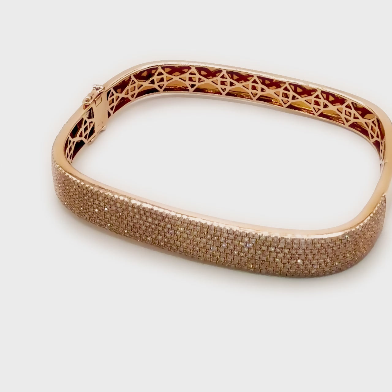 360-degree video of the Cuff Me bangle in 14k gold, displaying pavé-set diamonds and smooth inner structure.
