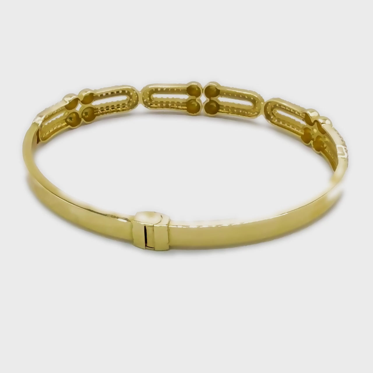 360-degree rotating video of the Bound To You bangle in 14k gold, showcasing U-shaped design and diamond sparkle from all angles.