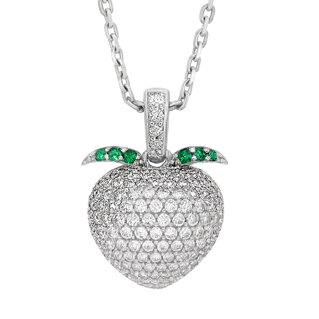 Silver necklace with a peach shaped pendant featuring green gemstones on a white background