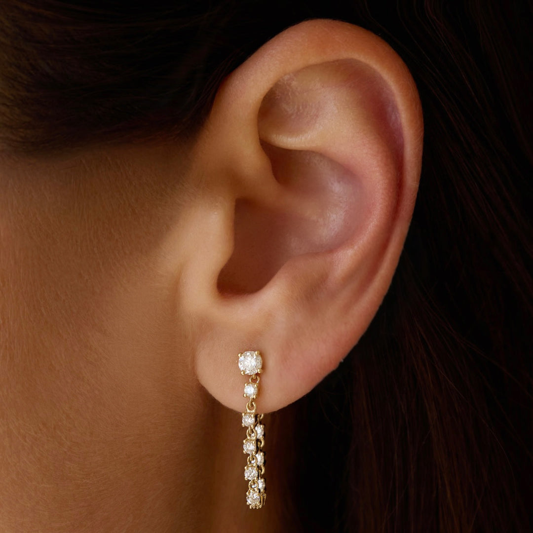 11:11 Line Drop Earring in yellow gold worn on ear, diamond linear design