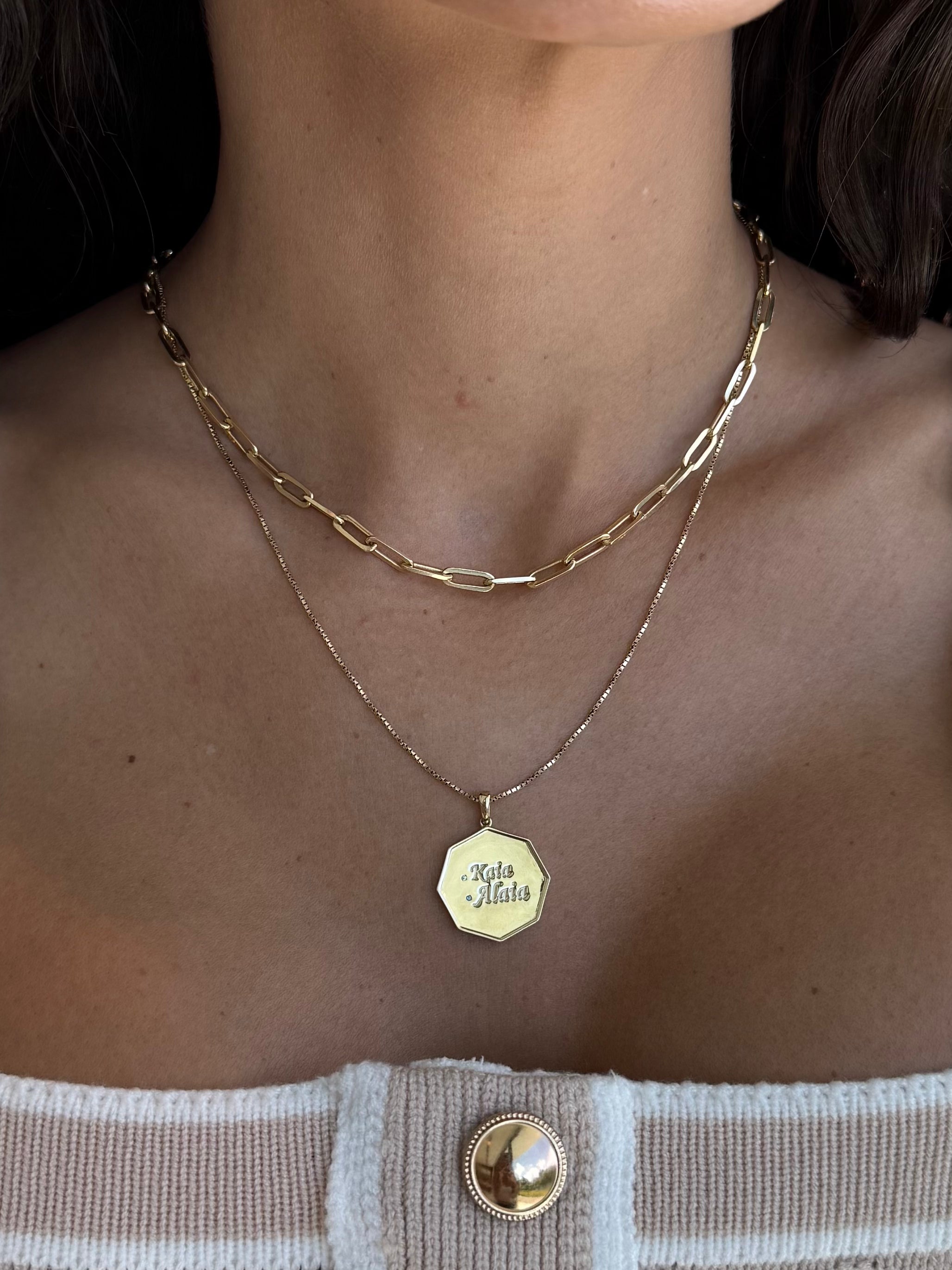 Alaia Namesake pendant in yellow gold and birthstones and name engravings on a model— Waltz Diamonds