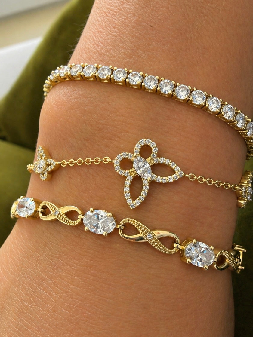 Butterfly Effect Bracelet in yellow gold featuring 3 butterflies with a marquise diamond center and pave wings  styled on wrist— Waltz Diamonds