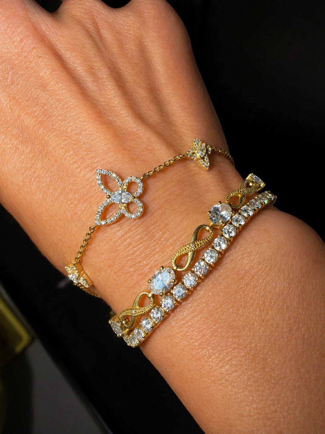 Butterfly Effect Bracelet in yellow gold featuring 3 butterflies with a marquise diamond center and pave wings  styled on wrist— Waltz Diamonds