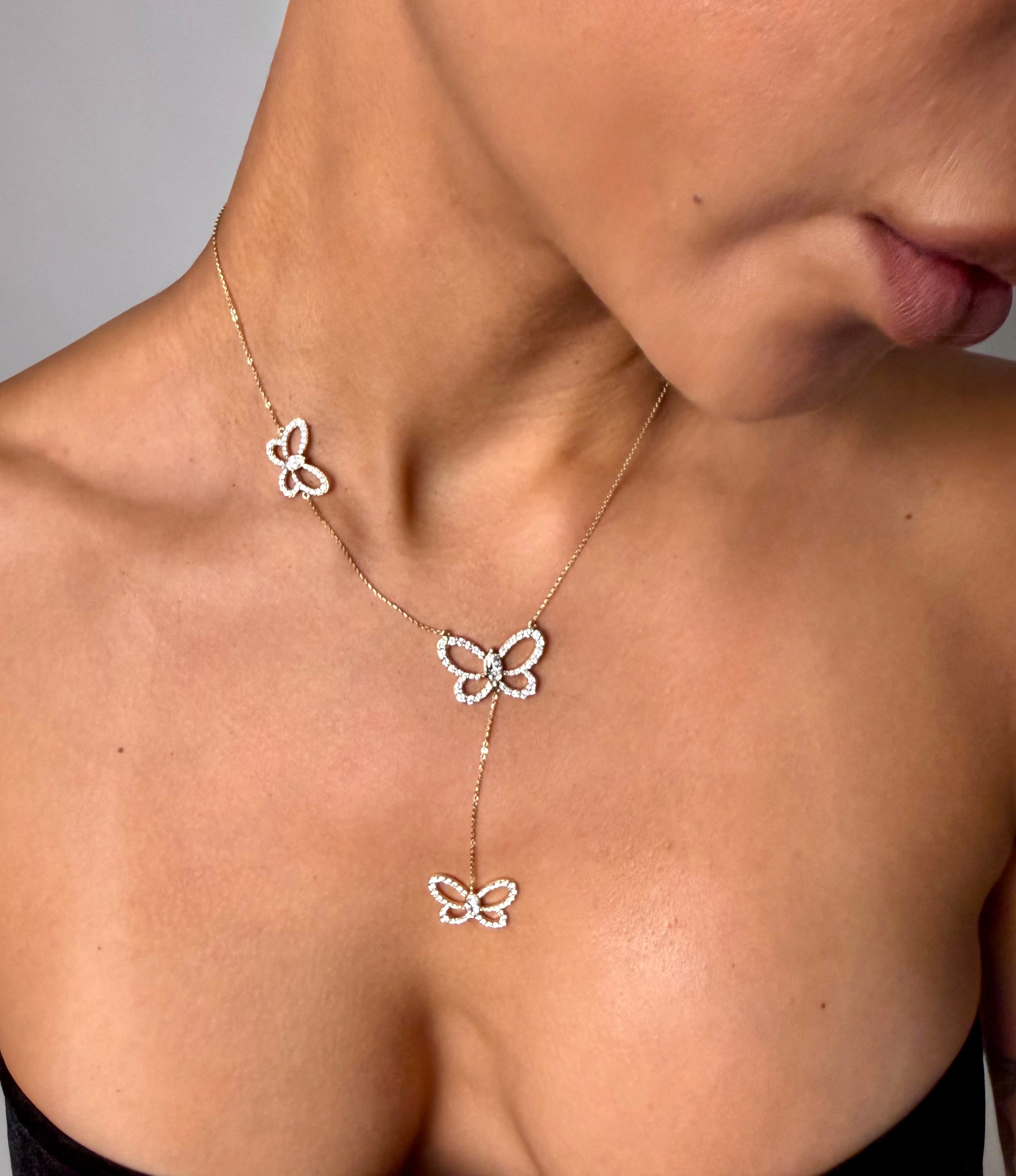 Butterfly Effect Lariat necklace with 3 suspended butterflies with marquise center stones in yellow gold on model — Waltz Diamonds
