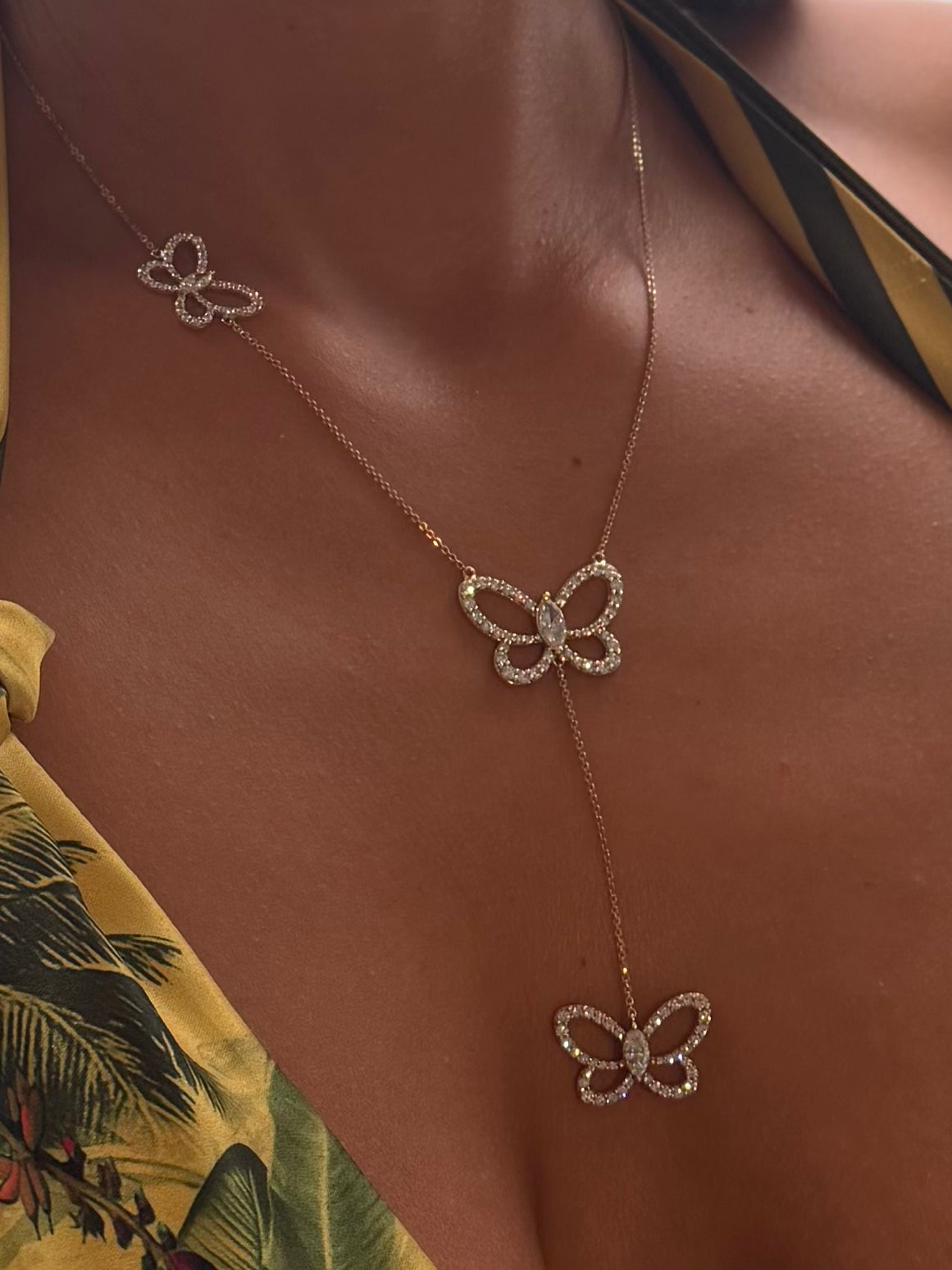 Butterfly Effect Lariat necklace with 3 suspended butterflies with marquise center stones in yellow gold on model — Waltz Diamonds