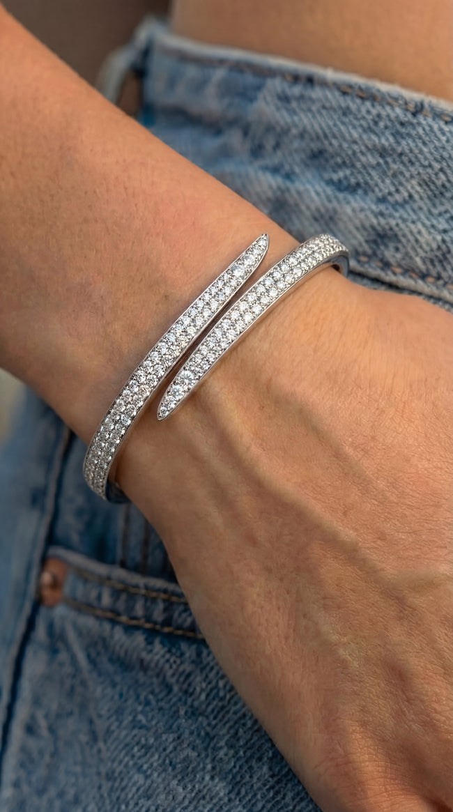 Bypass the rules diamond pave bypass bangle in white gold worn close-up on model—Waltz Diamonds