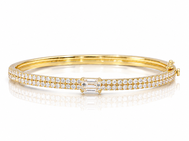 The clarity bangle featuring a double pave row of diamonds with an emerald cut diamond in the center — Waltz Diamonds
