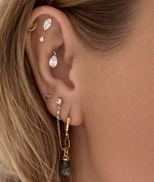 Cleos Lucky ear charm stacked on models ear — Waltz Diamonds