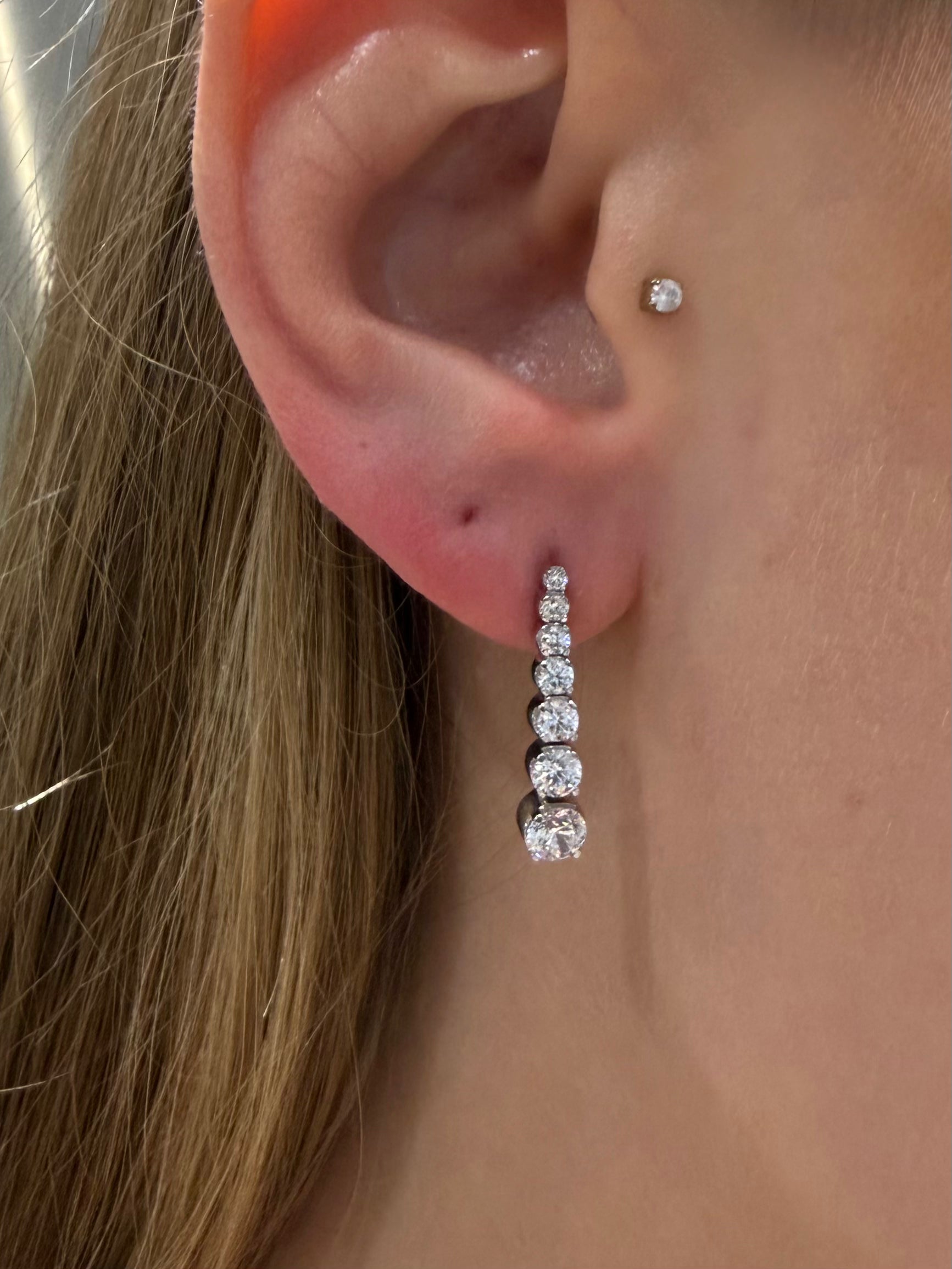 Crescendo Diamond Drops - Graduated Diamond Earrings white gold on ear — Waltz Diamonds