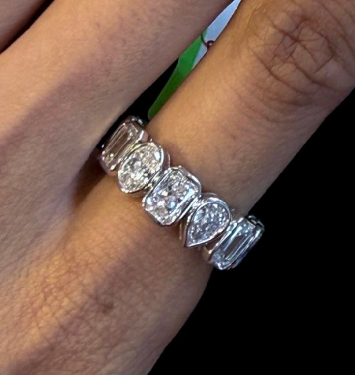 Cut Different multi-shaped bezel set eternity band in white gold on hand — Waltz Diamonds