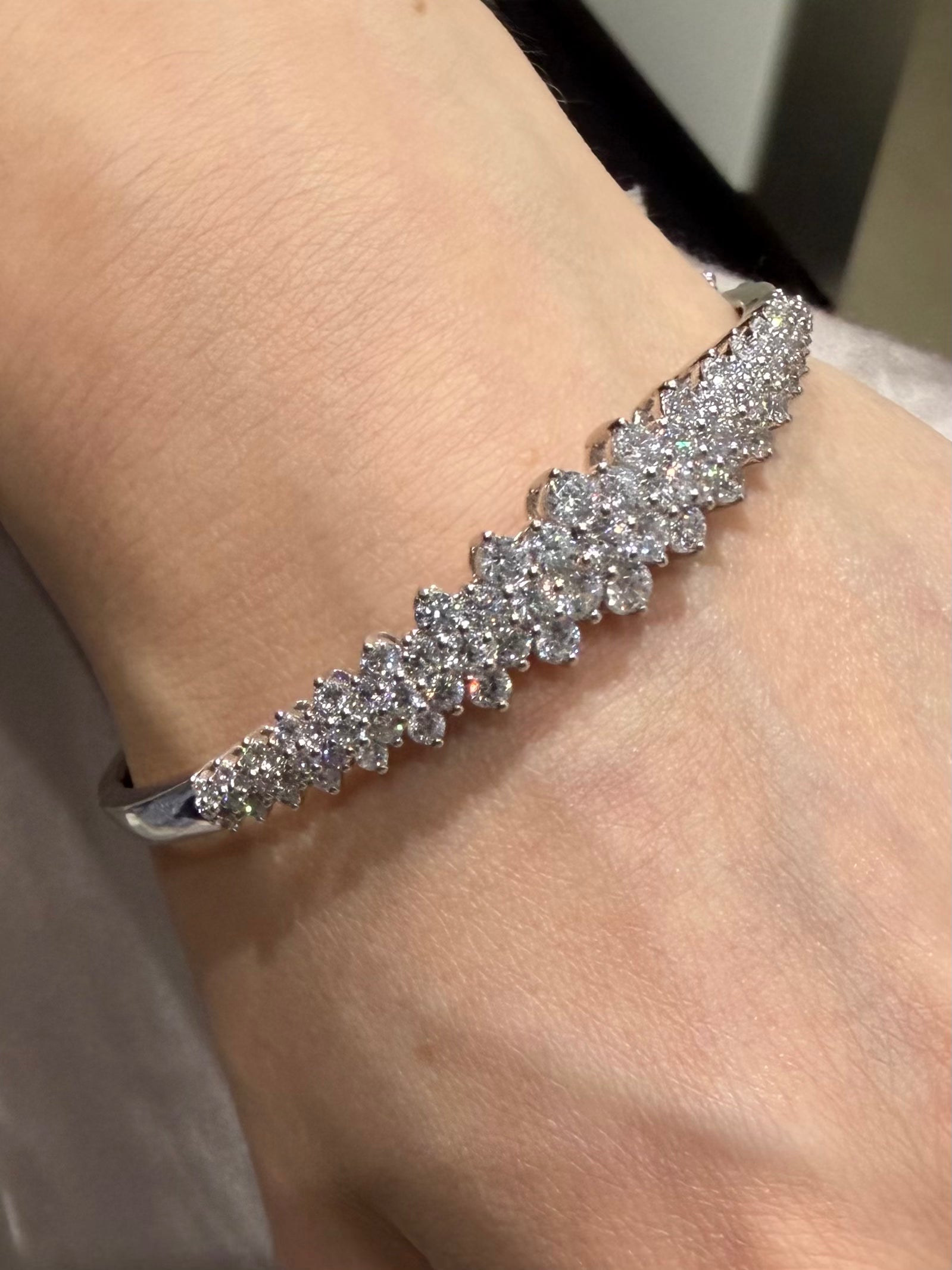 Darling Diamond cluster bangle in white gold on wrist — Waltz Diamonds