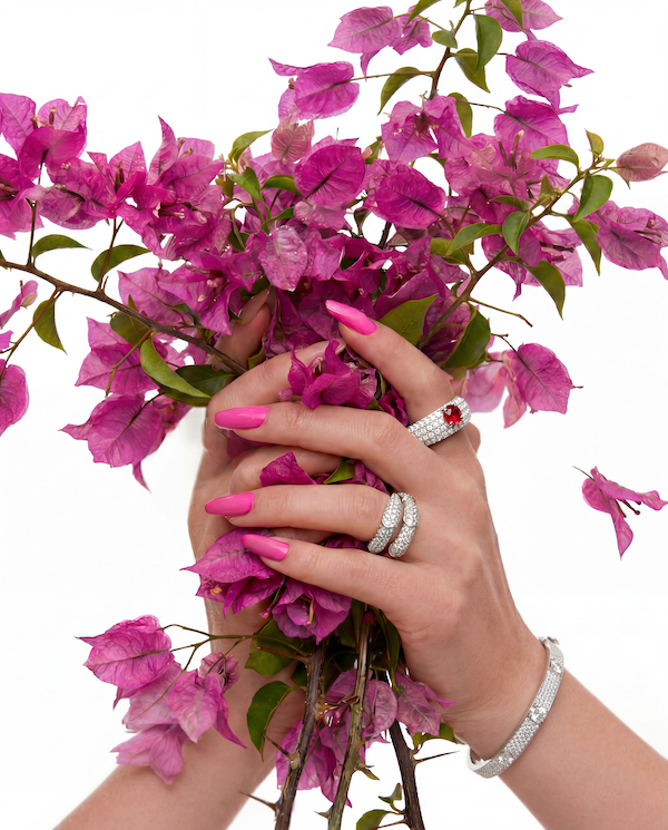 Secret portal ring and the Eclipse oil ring both in white gold on a woman holding flowers—Waltz Diamonds