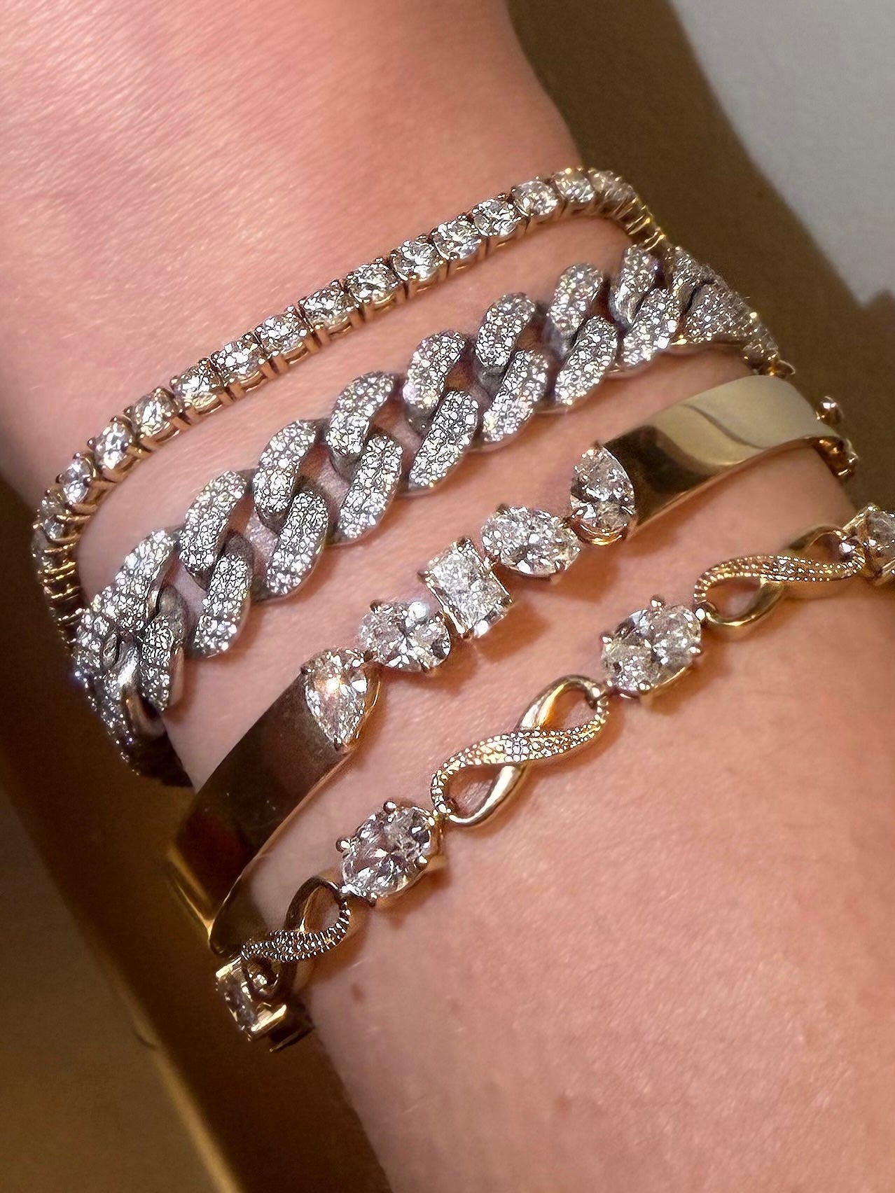 Stacked wrist of Waltz bracelets including El Jefe cuban, Mimi, abundance, and spoil me — Waltz Diamonds
