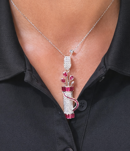 Model wearing Fore Play Pendant featuring diamonds and ruby baguettes in a golf bag charm design — Waltz Diamonds