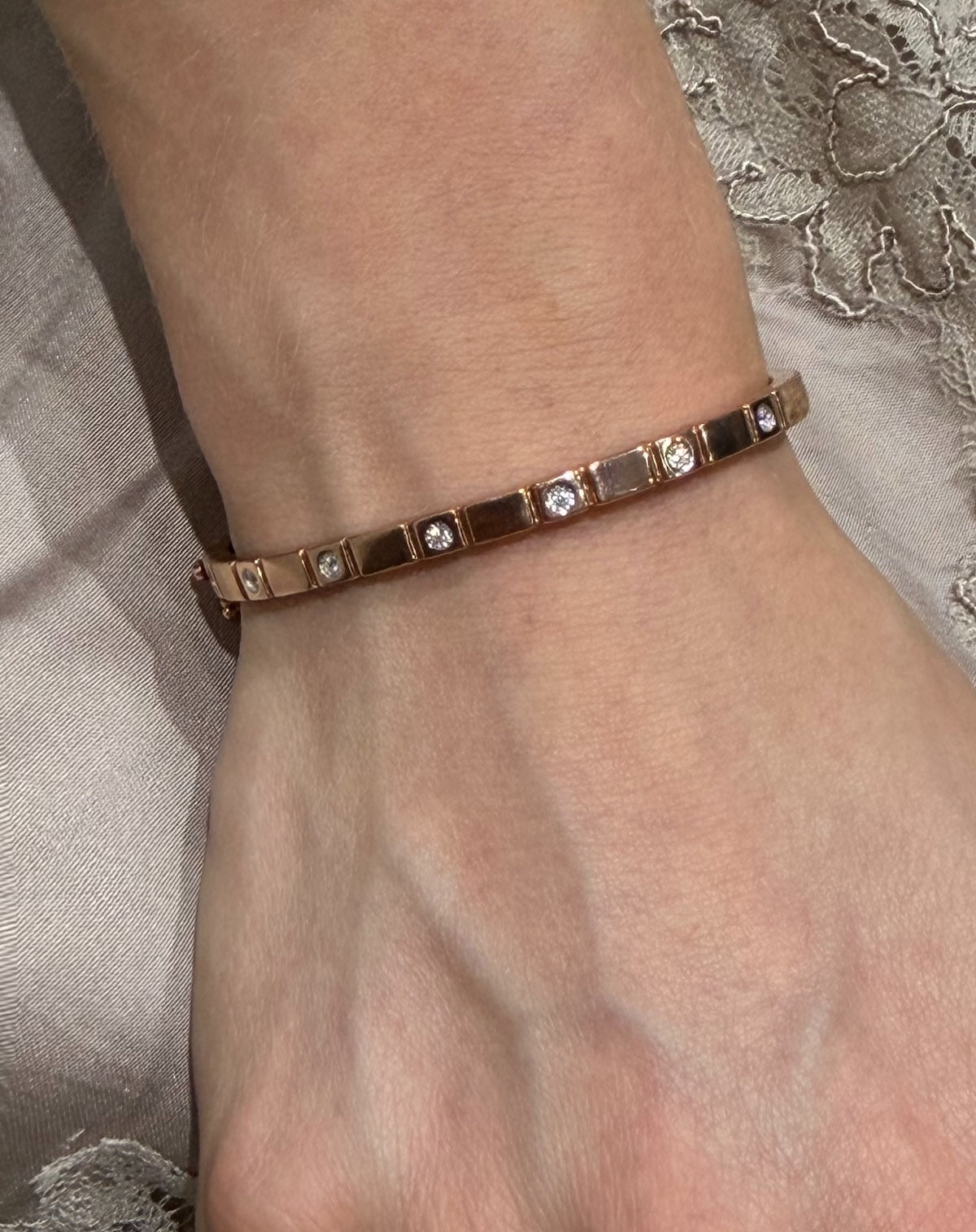 Groove Bangle features six bezel diamonds with a grooved design in rose gold  shown on wrist — Waltz Diamonds