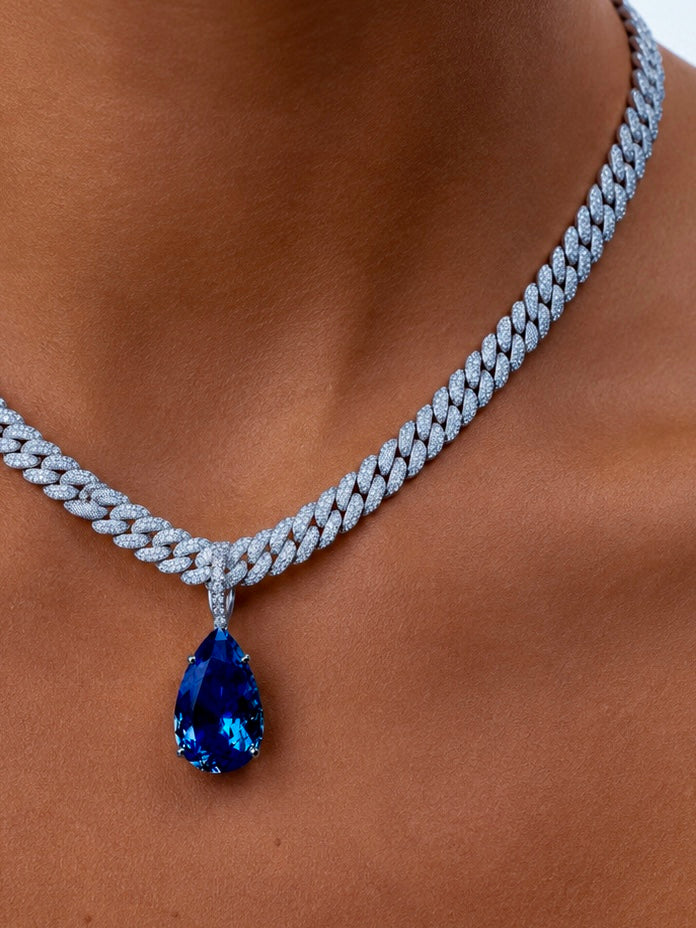 Heiress Sapphire pear pendant in white gold and diamond opening enhancer bail styled on model— Waltz Diamonds