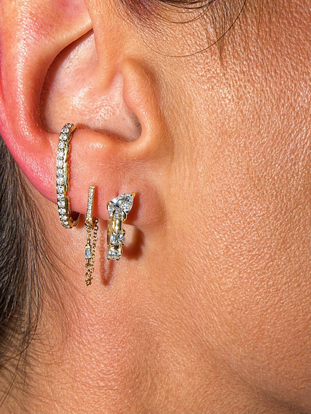 Hybrid Huggies paired with Luna Light studs shown on models ear — Waltz Diamonds