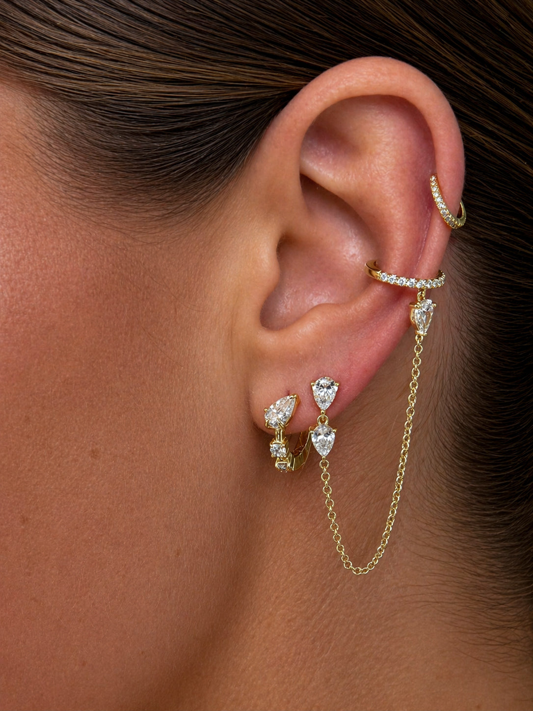 Hybrid huggies paired with the side piece cuff styled on models ear — Waltz Diamonds