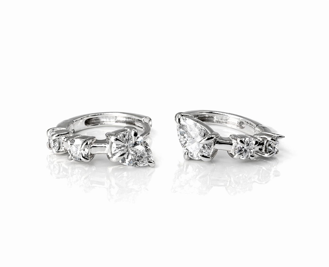 Hybrid Huggies featuring a pear cut top diamond and two round in yellow white — Waltz Diamonds