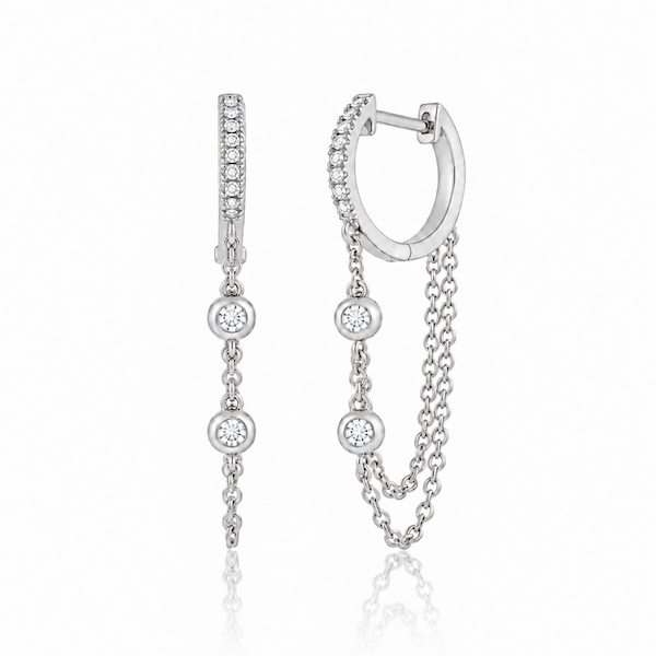 Looped in diamond chain huggies featuring a diamond pave huggie with a double looped chain with two bezel set diamonds white gold — waltz Diamonds