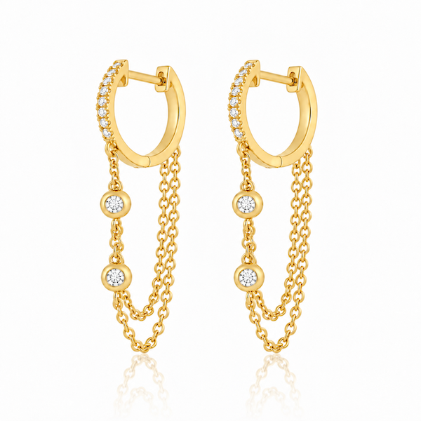 Looped in diamond chain huggies featuring a diamond pave huggie with a double looped chain with two bezel set diamonds yellow gold — waltz Diamonds