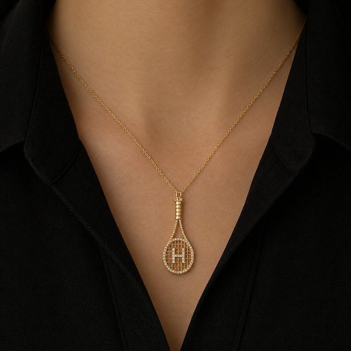 Love all diamond tennis racket pendant in yellow gold worn on model—Waltz Diamonds