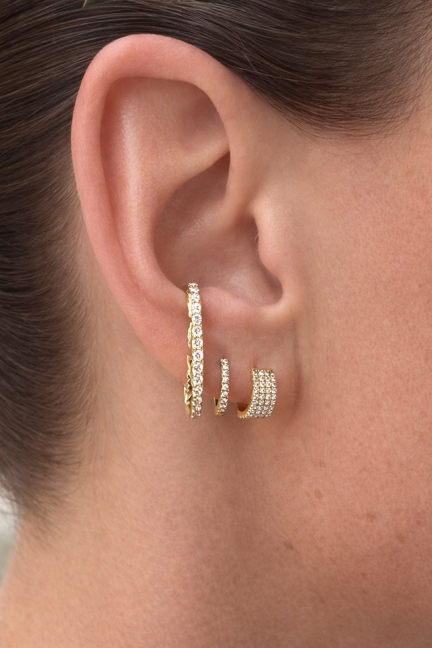 Luna light studs in yellow gold styled on models ear — Waltz Diamonds 