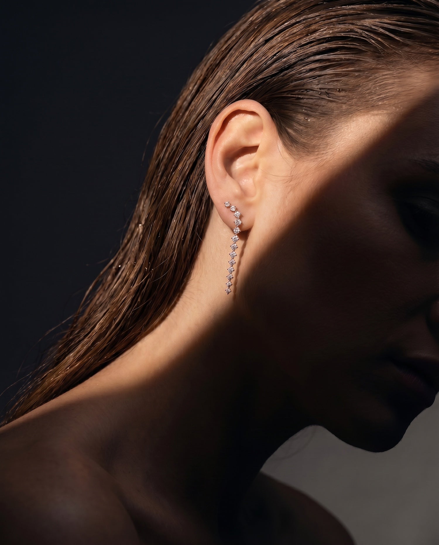 Lyrical descent diamond drop earrings on model — Waltz Diamonds