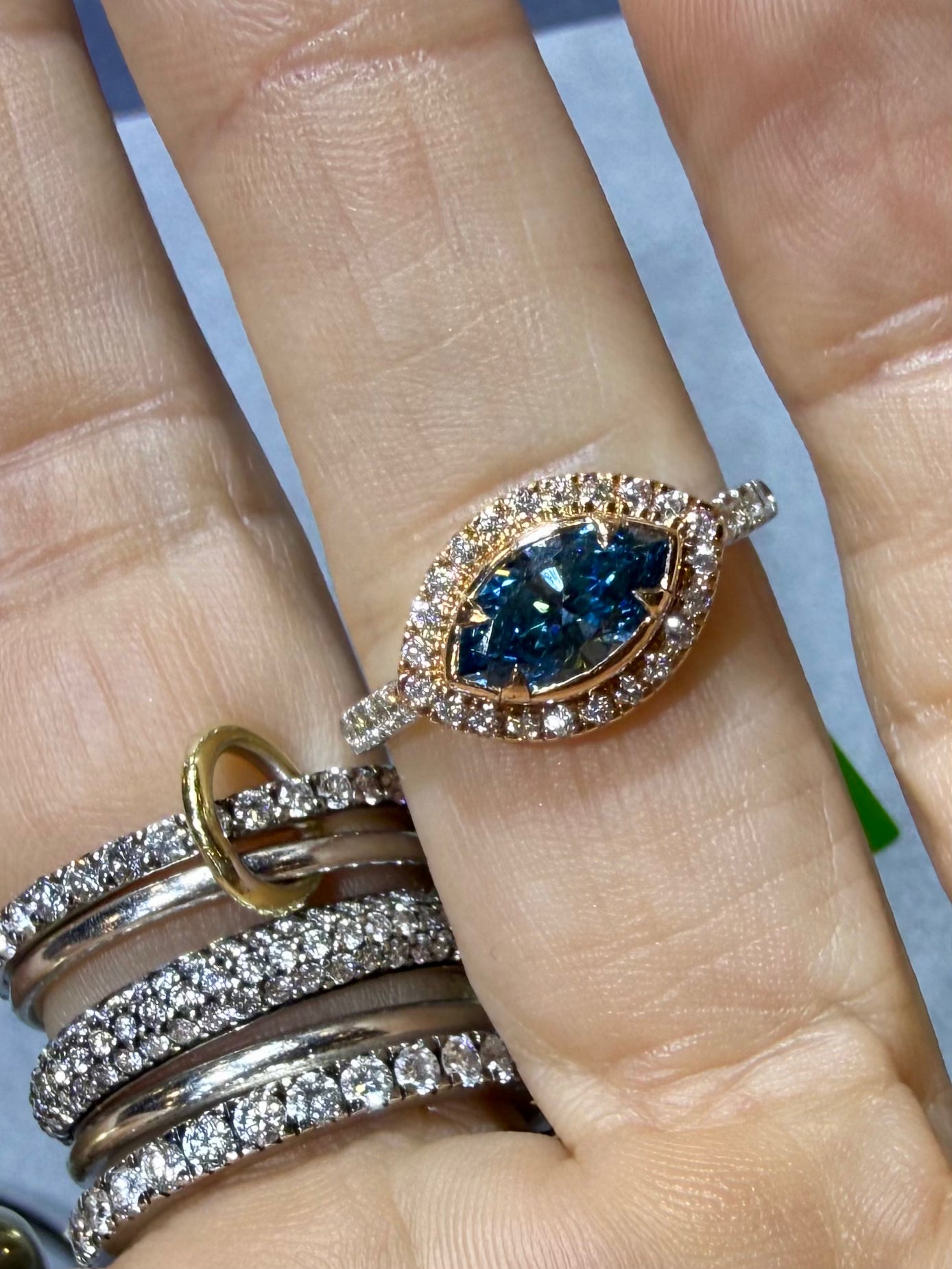 Ocean eye Blue diamond evil eye ring in yellow gold with a diamond halo  on hand— Waltz Diamonds