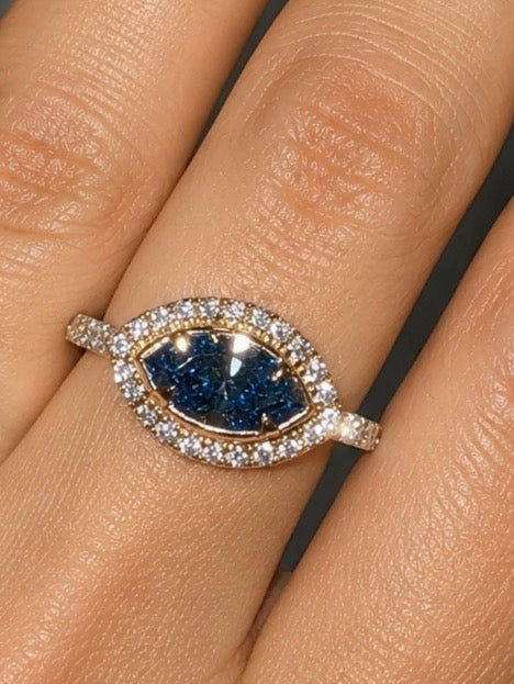 Ocean Eye Halo Ring blue diamond center surrounded by diamonds on finger — Waltz Diamonds