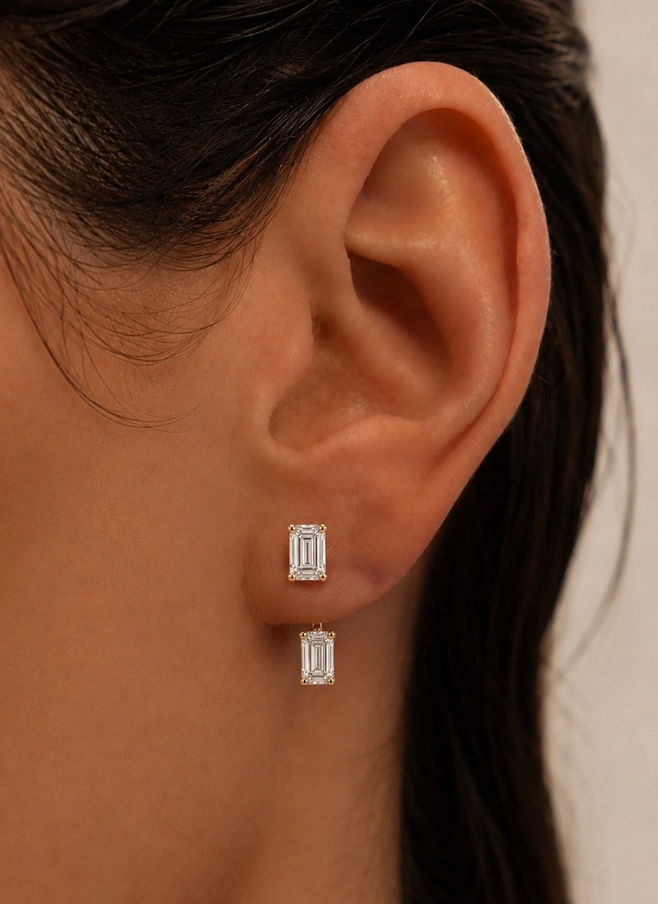 Orbit diamond earring jackets in emerald cut and yellow gold shown on models ear —  Waltz Diamonds