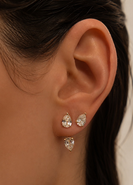 Orbit diamond earring jackets in pear cut and yellow gold shown on models ear —  Waltz Diamonds