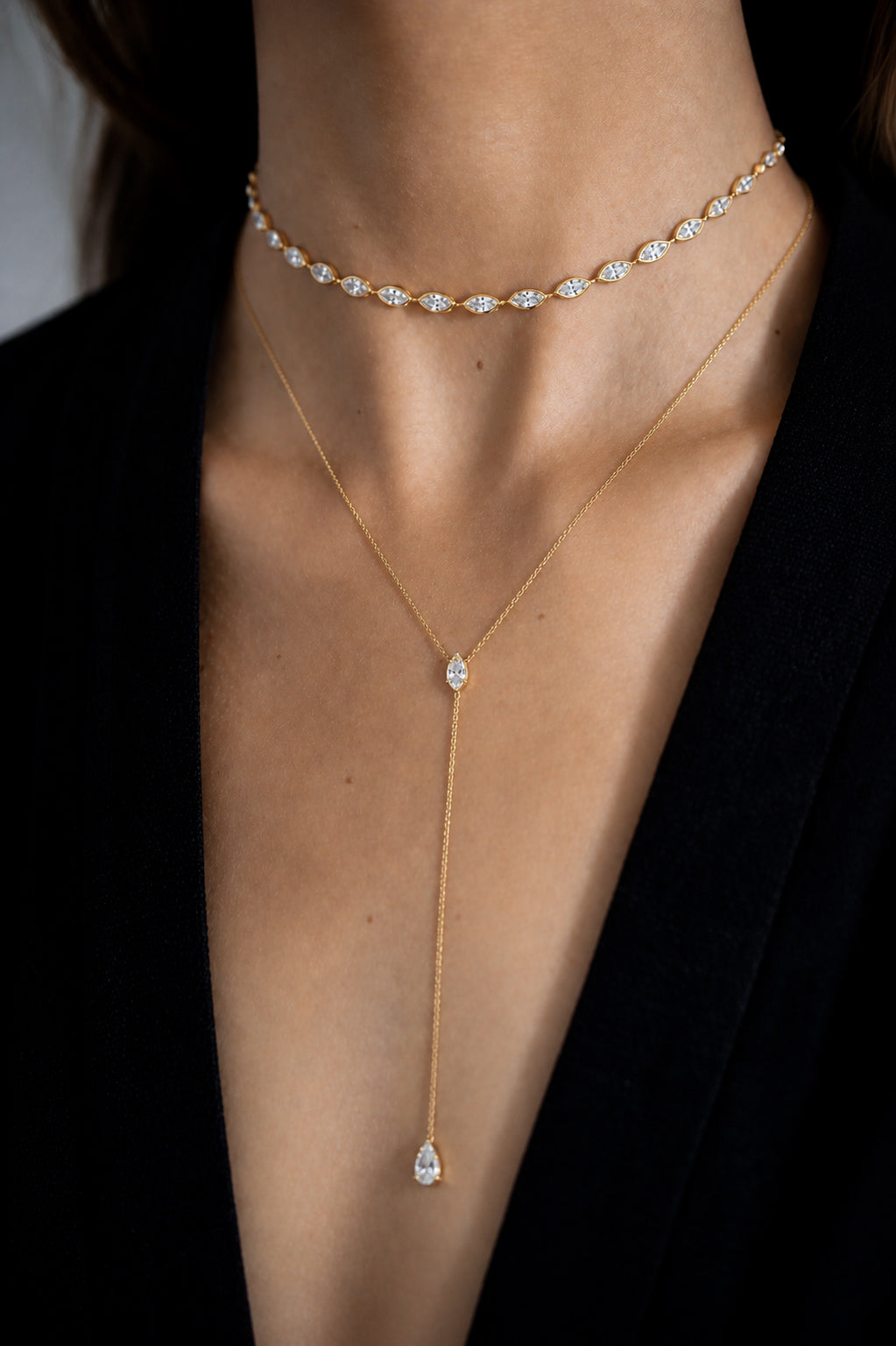 Oria Marquise Choker with 14 bezel-set marquise cut diamonds rose gold styled on model also wearing Fine Line Lariat— Waltz Diamonds