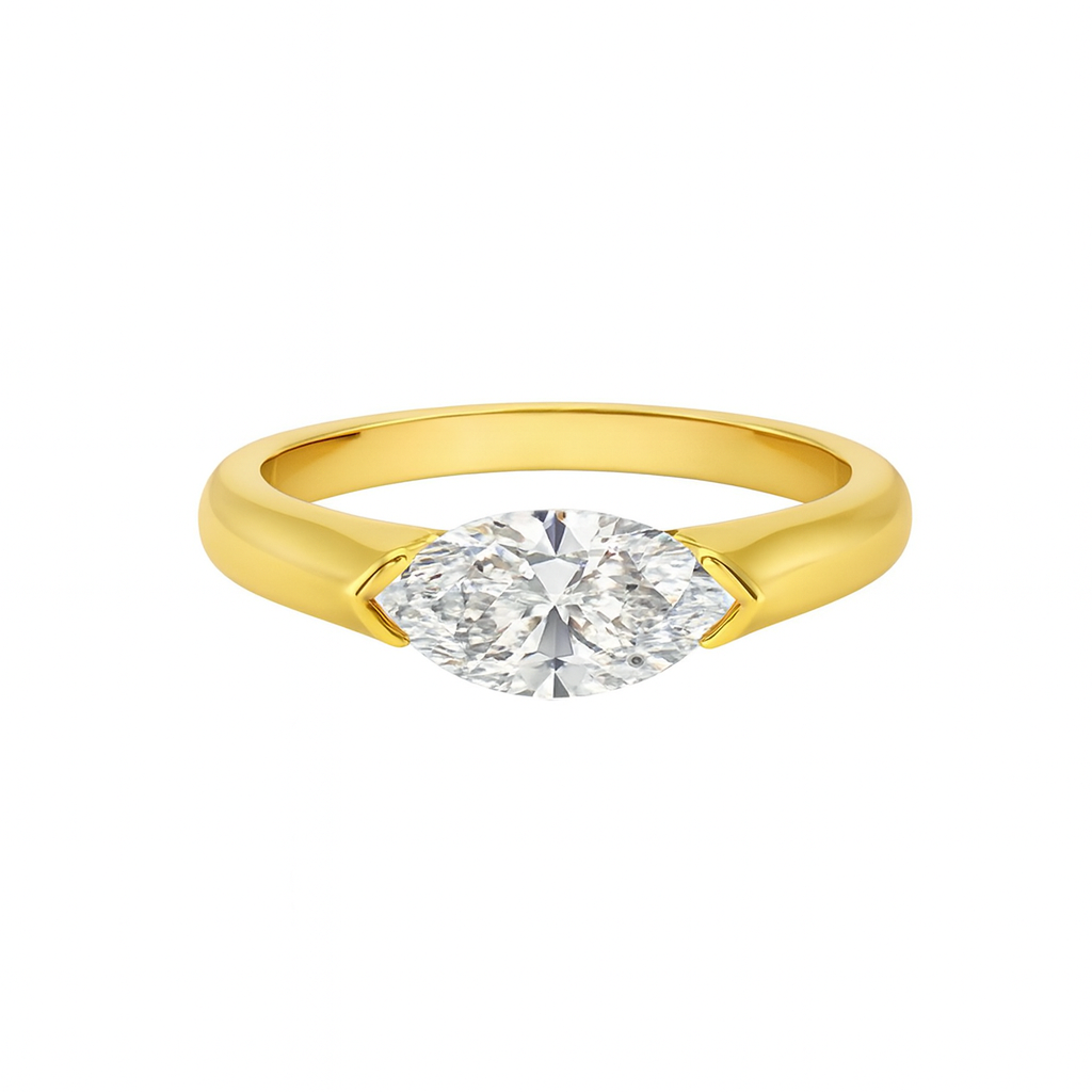 Yellow Gold ring with a marquise lab diamond on a white background