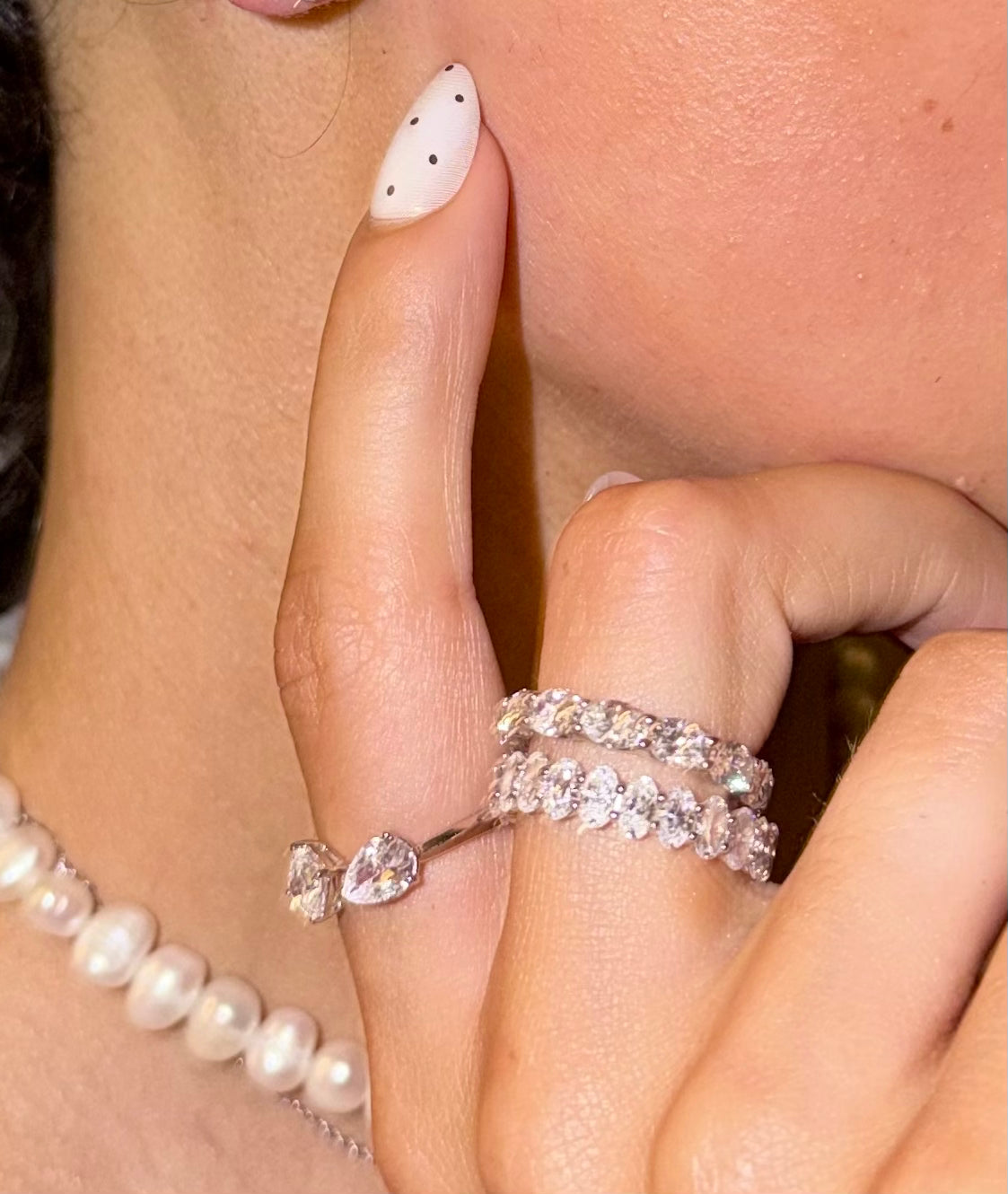 Princess pear ring featuring a pear cut and a princess cut diamond in an open asymmetrical setting white gold on hand — Waltz Diamonds