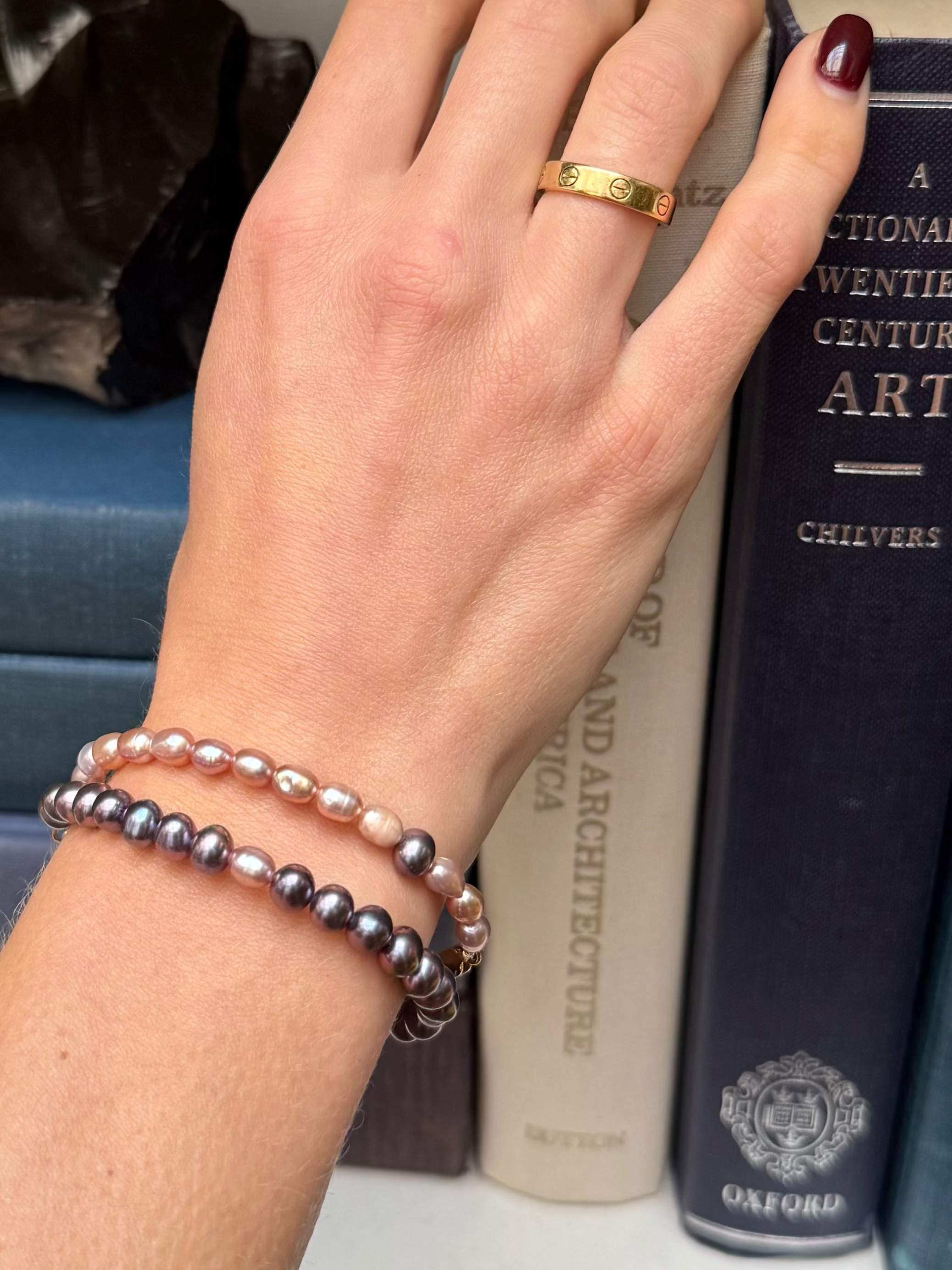 Prosperity pearl bracelets in peacock and blush on models arm—Waltz Diamonds