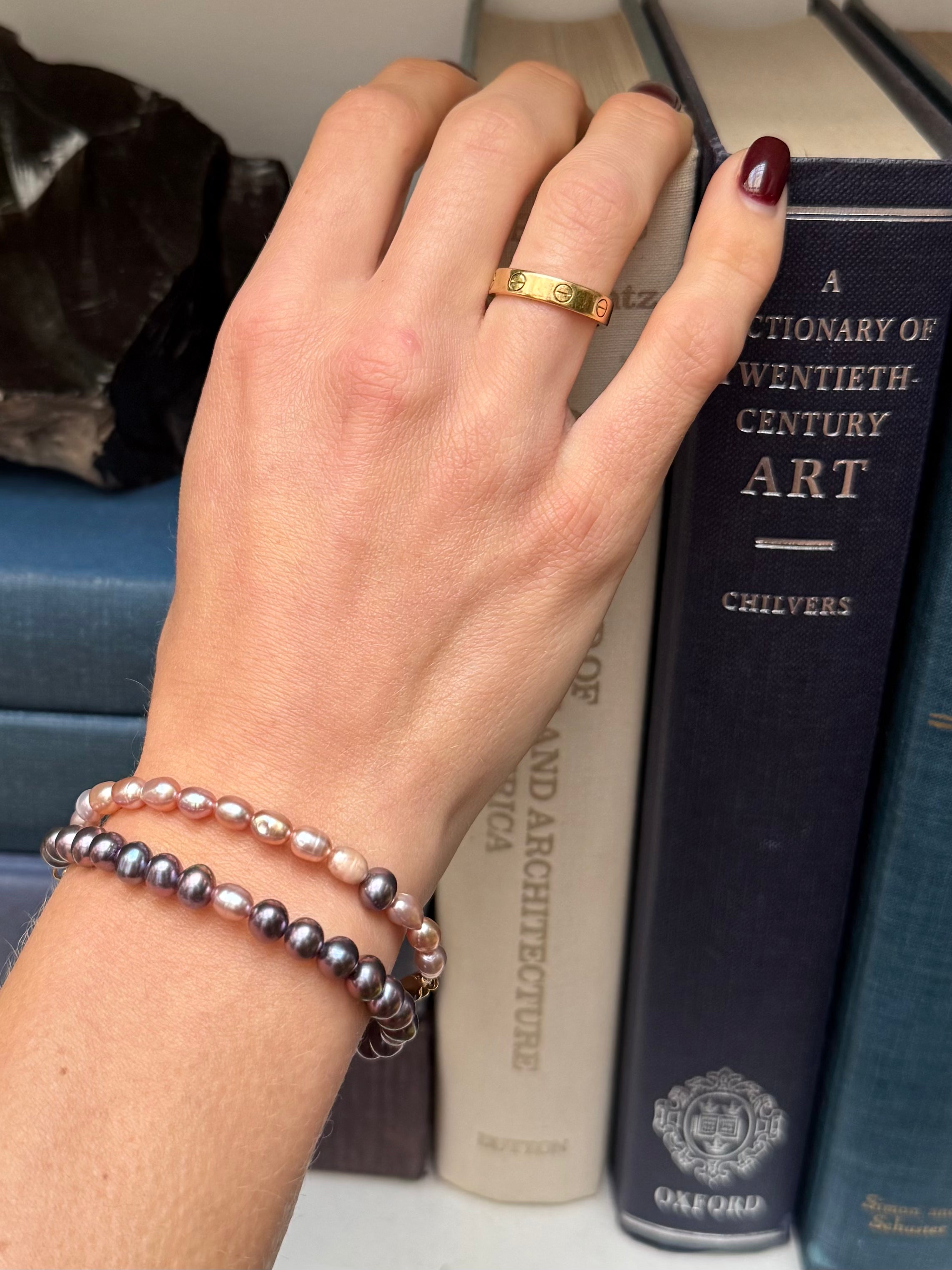 Prosperity pearl bracelets in peacock and blush on models arm—Waltz Diamonds