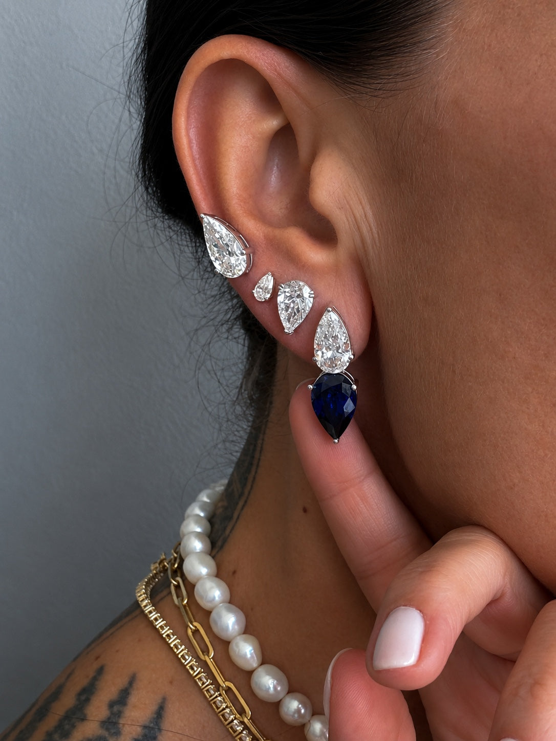 Raindrop Duo Stud elongated pear cut diamond and sapphire earring white gold styled with several pear studs — Waltz Diamonds
